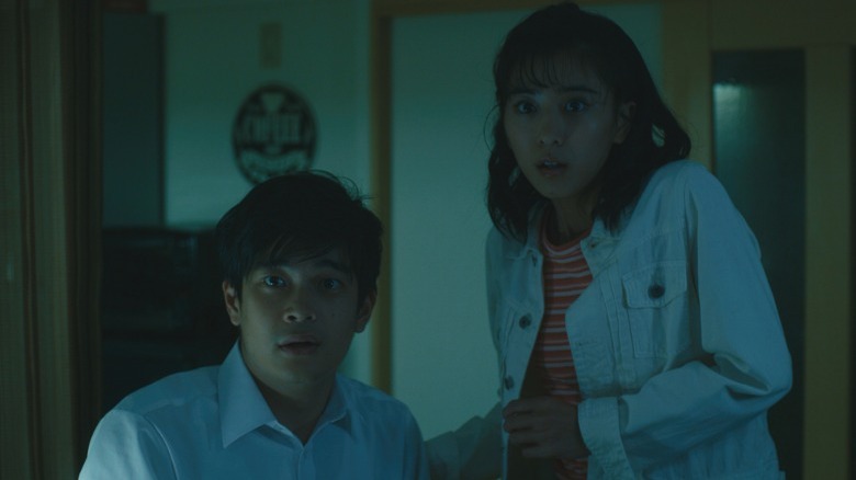 Ju-On: Origins Tetsuya and Haruka scared in dark house
