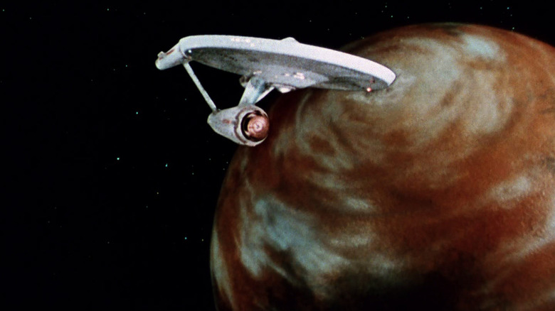 Star Trek's original Enterprise orbits a planet