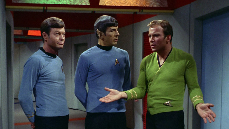 DeForest Kelley as McCoy, Leonard Nimoy as Spock, and William Shatner as Kirk reflect upon the events of the Star Trek episode The Apple