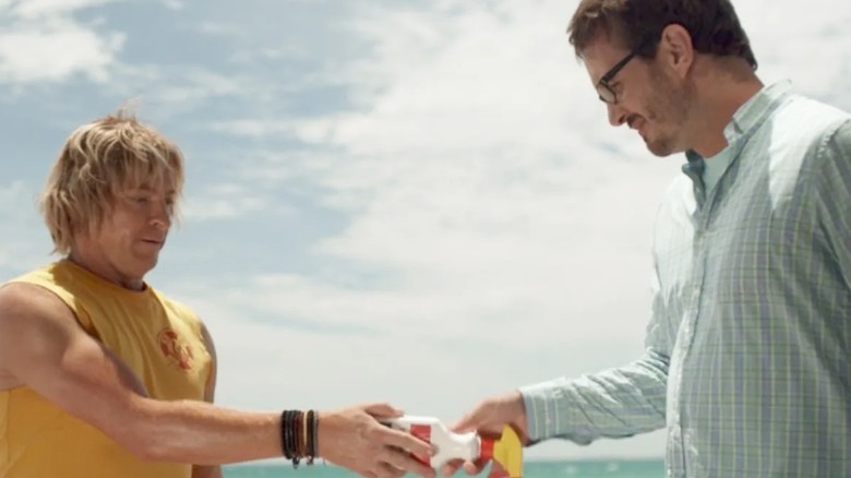 Terry handing David Farrier bottle