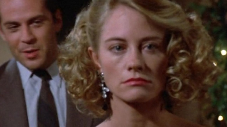 Bruce Willis' David stands behind Cybil Shepherd's Maddie, who is about to cry, in Moonlighting