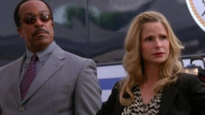 Robert Gossett's Russell and Kyra Sedgwick's Brenda look with concern offscreen in The Closer