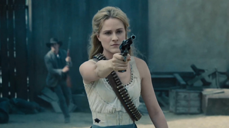 Evan Rachel Wood as Dolores Abernathy, aiming a pistol on HBO's Westworld