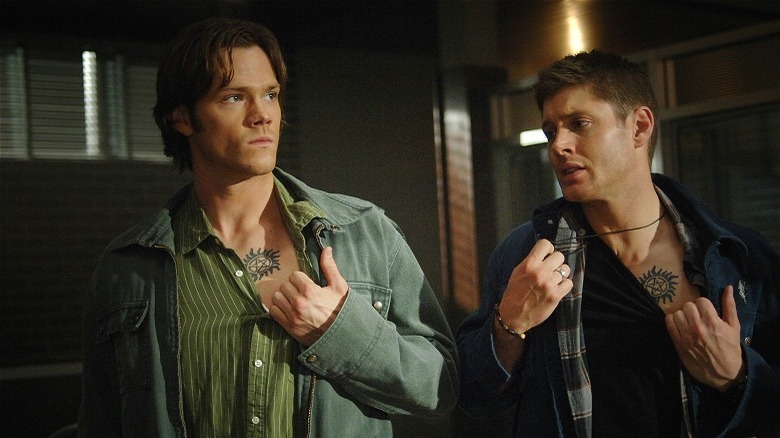 Sam and Dean showing protective tattoos