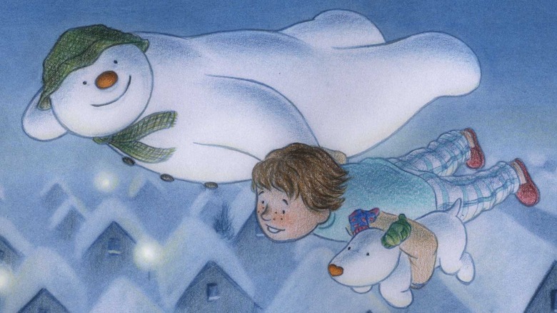 Snowman and snowdog flying with kid