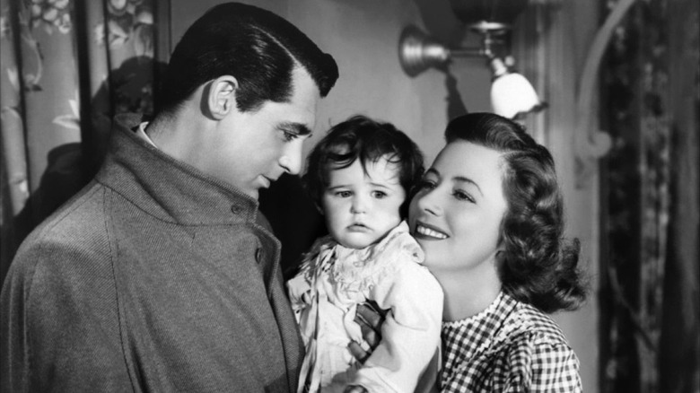 Cary Grant looks at a baby adoringly