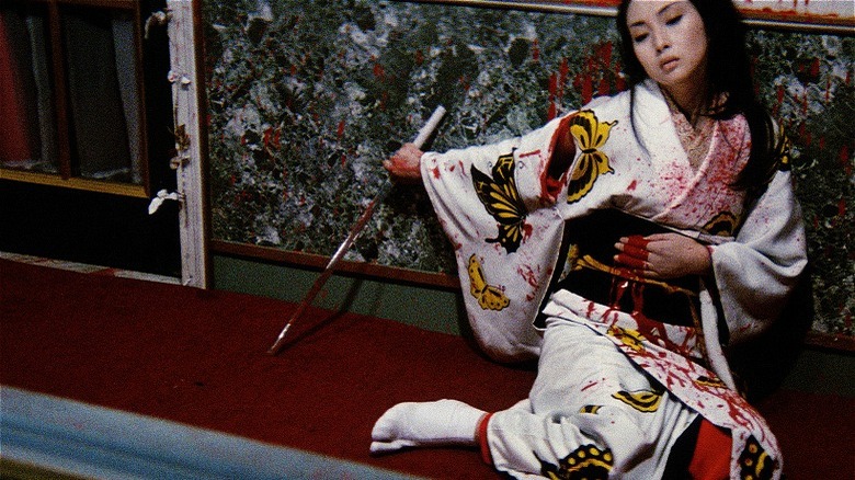 Lady Snowblood holding sword and clutching bloody stomach