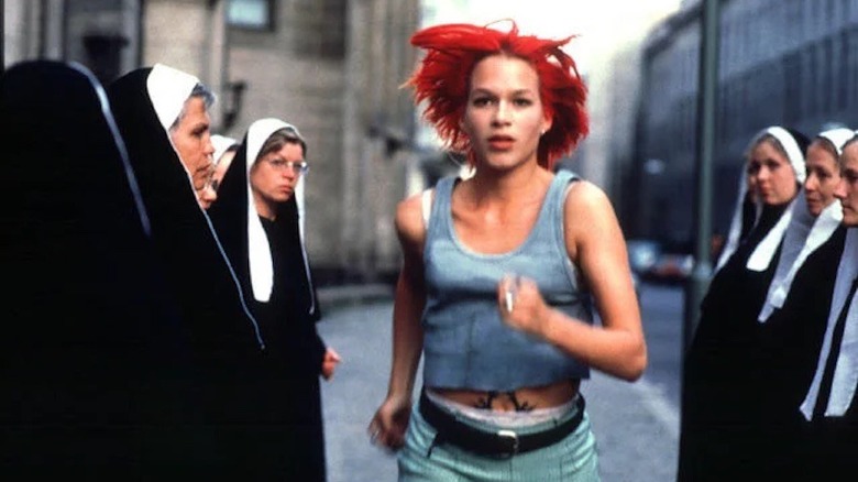 Red-haired Lola running past group of nuns in Run Lola Run