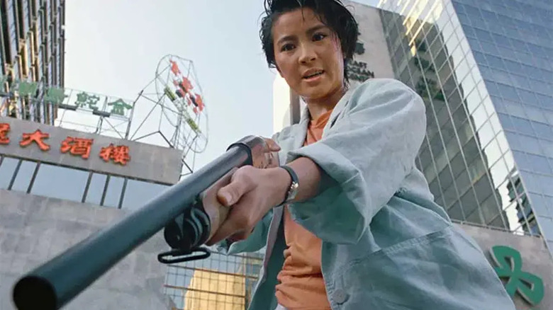 Short-haired Michelle Yeoh holding shotgun in Yes, Madam! 