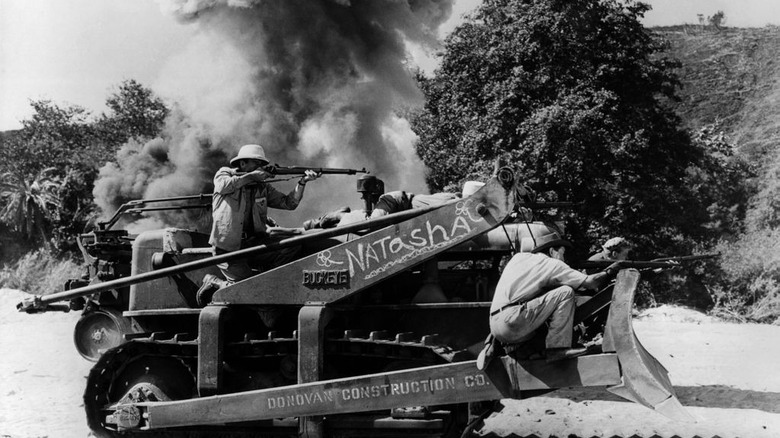 The Fighting Seabees Donovan rides a bulldozer