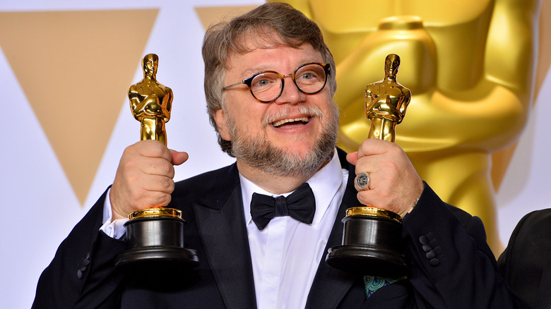 Guillermo del Toro holding his Oscars