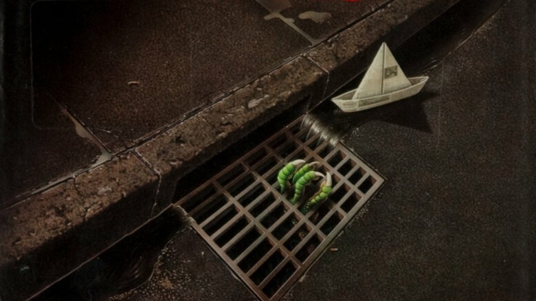 Original hardcover of It, featuring a child's paper boat and a monstrous hand in a sewer.