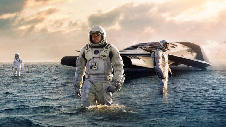 Matthew McConaughey and ensemble in spacesuits in Interstellar