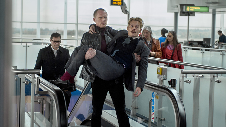 Paul Bettany's Jock carrying Johnny Depp's Charlie Mortdecai at the airport in Mortdecai