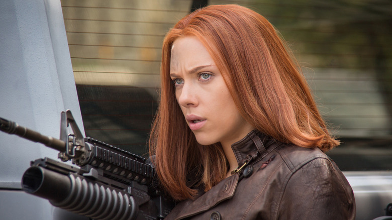 Black Widow points a rifle in Captain America: The Winter Soldier