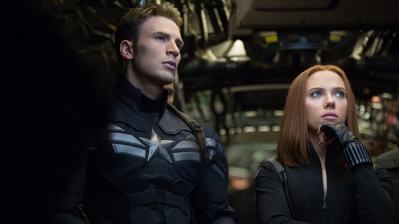 Steve Roges and Black Widow stand in a Quinjet cargo hold in Captain America: The Winter Soldier