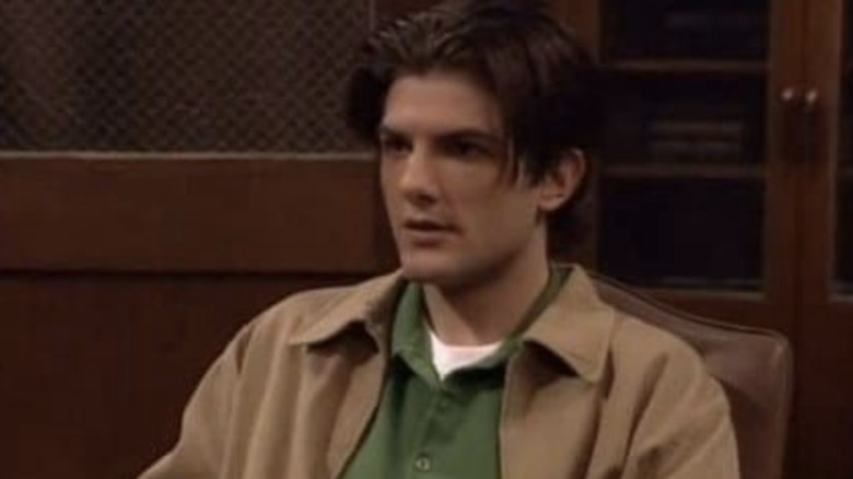 Adam Scott's Griff sits in a chair looking worried in Boy Meets World