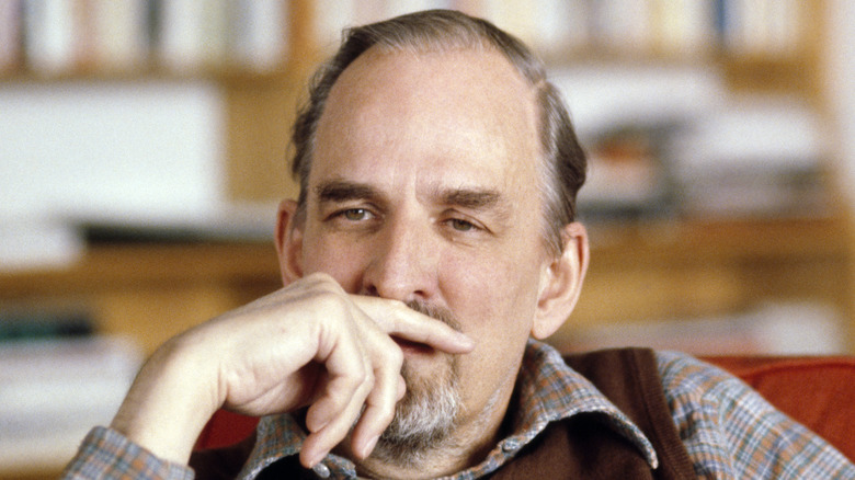 Ingmar Bergman sitting in front of bookcase