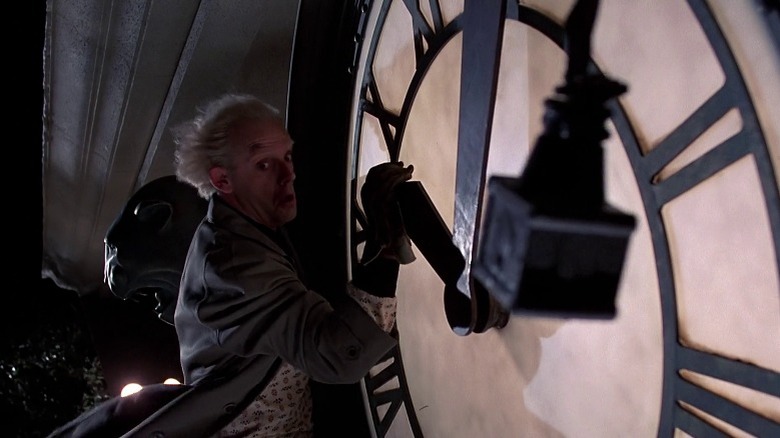 Doc Brown clinging to giant clock in Back to the Future