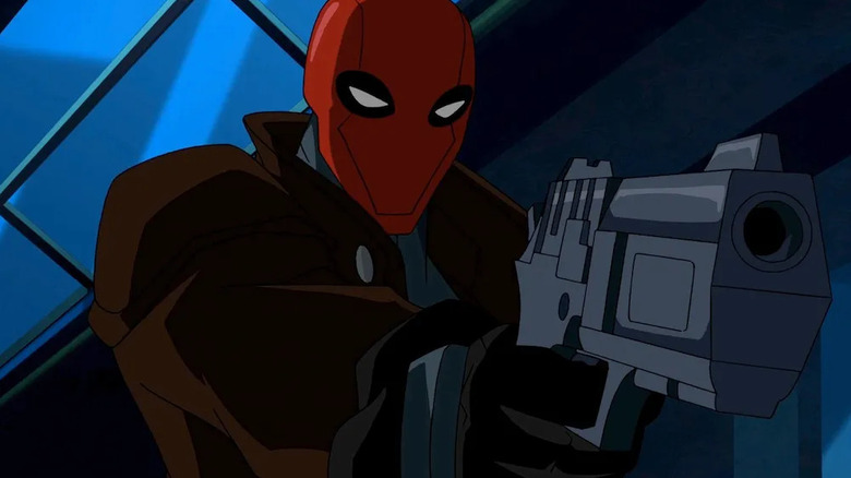 Red Hood aims a pistol in the animated film Batman: Under the Red Hood