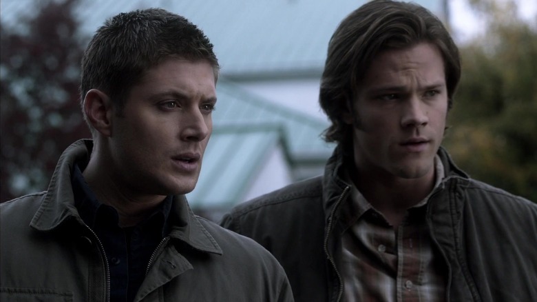 Dean (Jensen Ackles ) and Sam Winchester (Jared Padalecki) look concerned at something on Supernatural