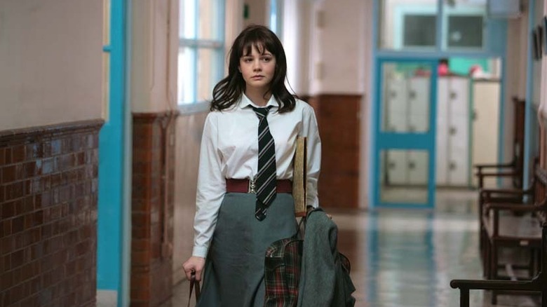 Jenny (Carey Mulligan) walks through a school hallway in An Education