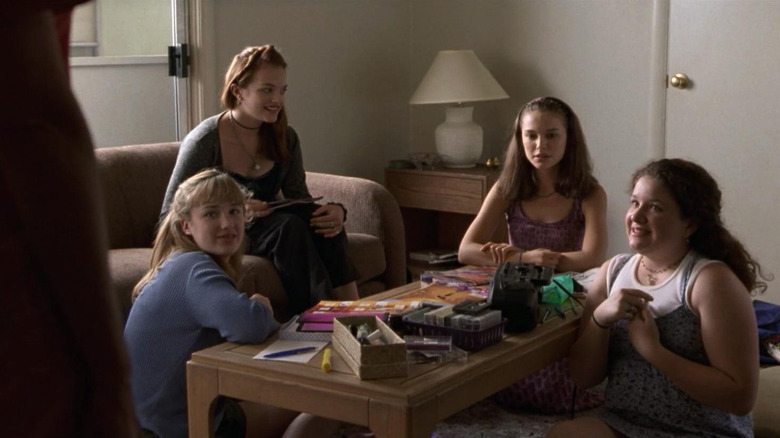 Ann (Natalie Portman) sits in a living room looking concerned with three teenage friends in Anywhere but Here