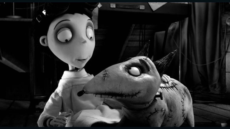 Victor Frankenstein (Charlie Tahan) pets his dog Sparky in Frankenweenie