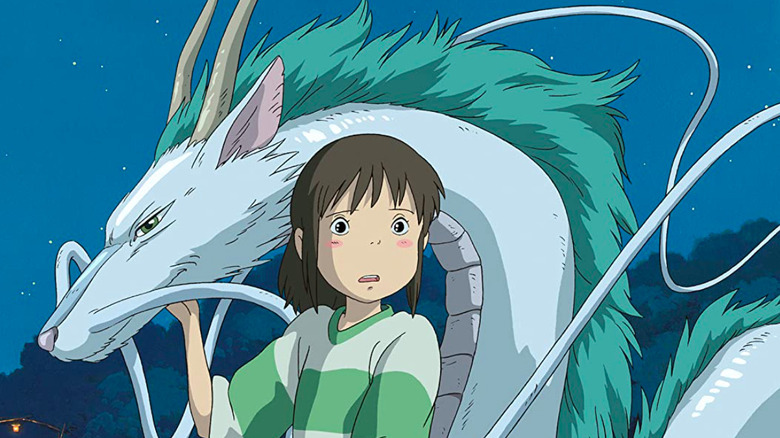 Chihiro Ogino (Rumi Hiiragi) touches a dragon in Spirited Away