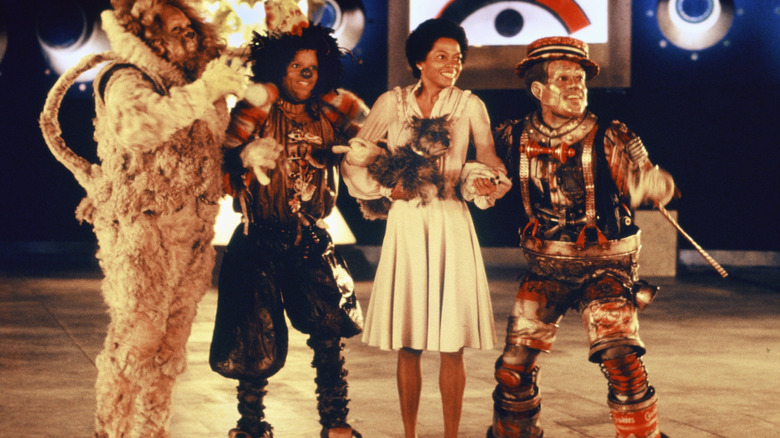 Cowardly Lion (Ted Ross), Scarecrow (Michael Jackson), Dorothy (Diana Ross), and Tinman (Nipsey Russell) smiling in The Wiz