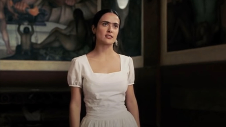 Frida's Salma Hayek standing in art gallery