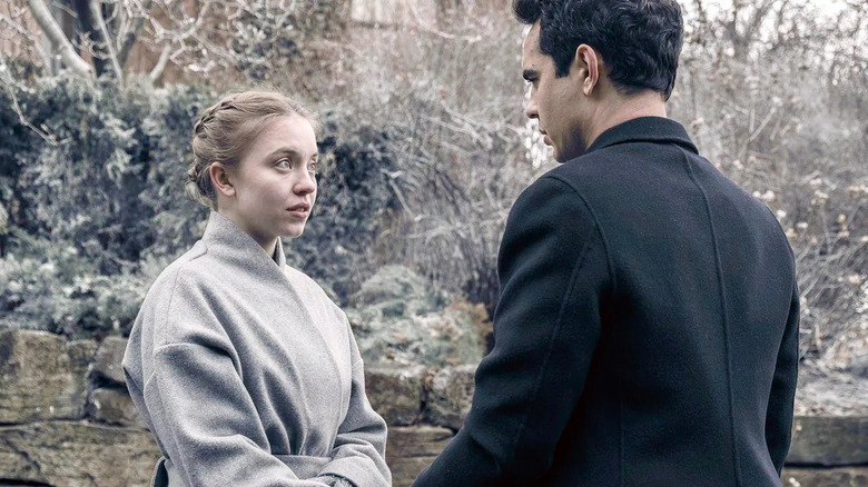 Sydney Sweeney as Eden and Max Minghella as Nick talking in front of trees in The Handmaid's Tale