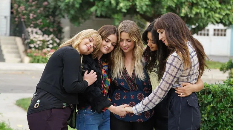 Aria (Lucy Hale) and her friends embrace each other in Pretty Little Liars