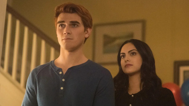 Archie Andrews (KJ Apa) stands next to Veronica Lodge (Camila Mendes) on Riverdale