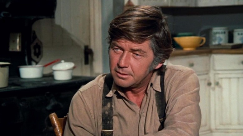 John Walton, Sr. (Ralph Waite) sits in the kitchen in The Waltons