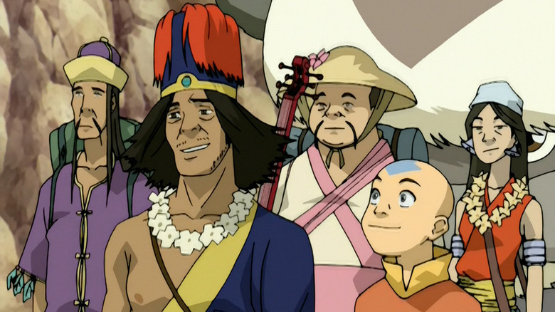 Aang stands with a group of hippies, Appa behind them