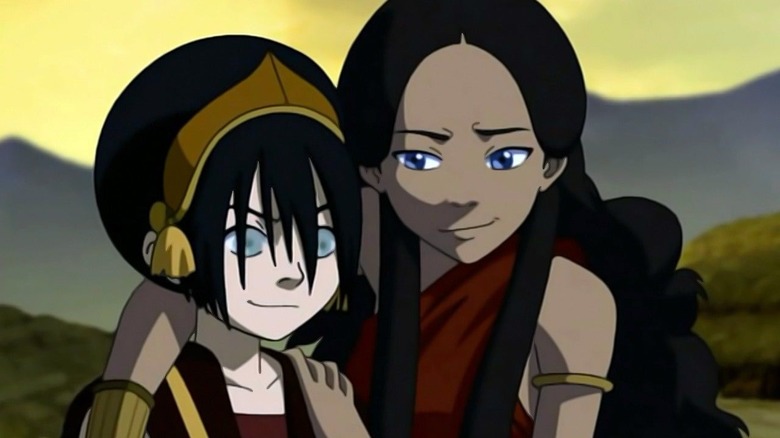 Katara puts an arm around Toph's shoulders