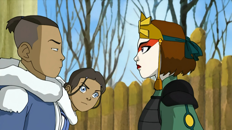 Sokka and Suki stare each other down as Katara watches