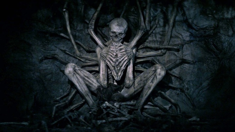 Skeleton creature crouching cave