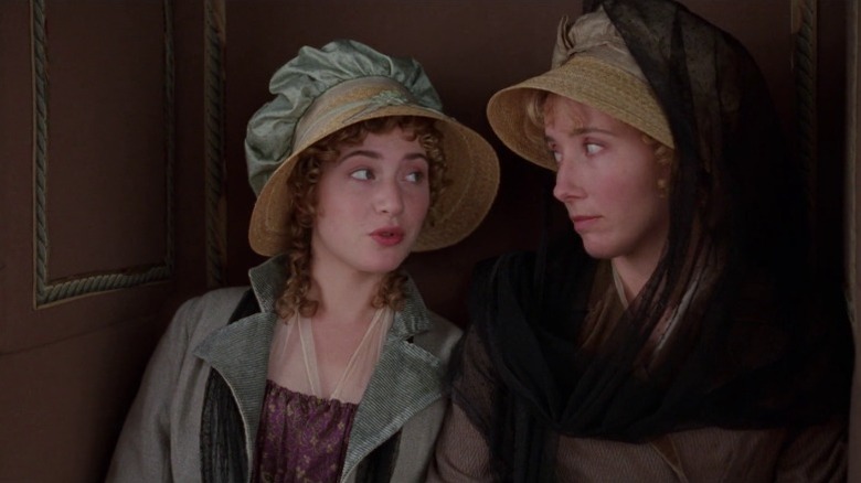 Kate Winslet as Marianne Dashwood and Emma Thompson as Elinor Dashwood sitting in a carriage and looking at each other in Sense and Sensibility