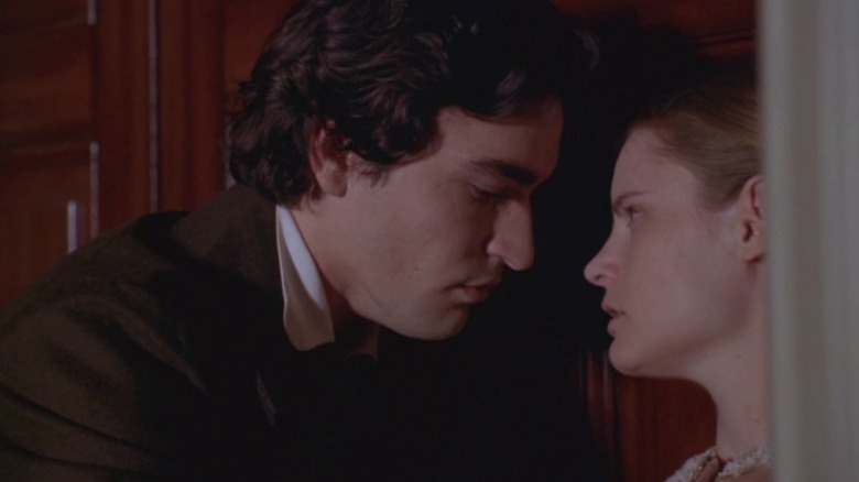 Jennifer Jason Leigh as Catherine Sloper glaring at Ben Chaplin as Morris Townsend while he leans in close to her in Washington Square