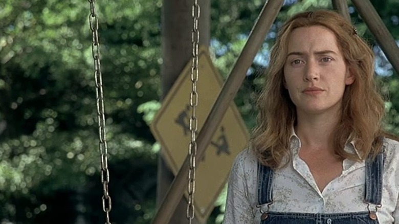 Kate Winslet standing near swing