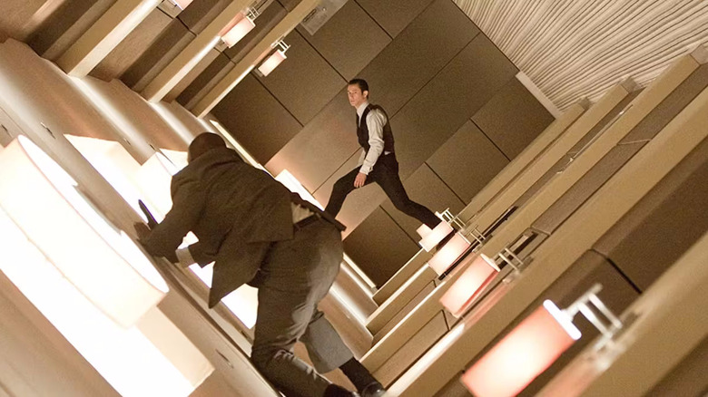 Joseph Gordon-Levitt as Arthur and a henchman in a suit fight in a spinning hallway in Inception (2010)