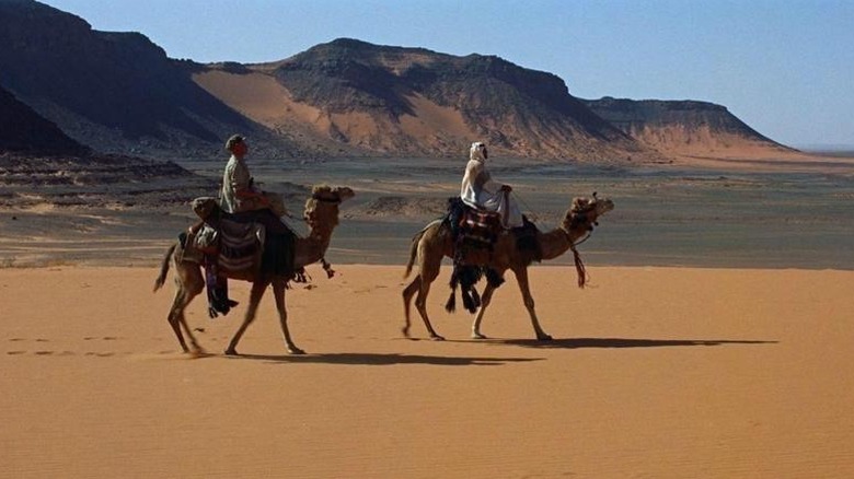 T. E. Lawrence and his attendee ride camels in the Syrian desert in Lawrence of Arabia (1962)