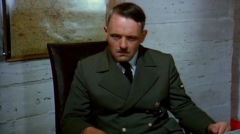 Hitler sitting at a desk 