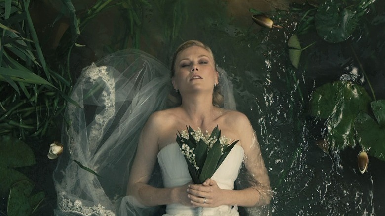 Kirsten Dunst laying in pond in Melancholia