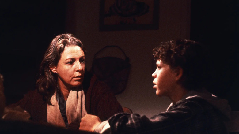 Woman sitting at table with boy in Testament