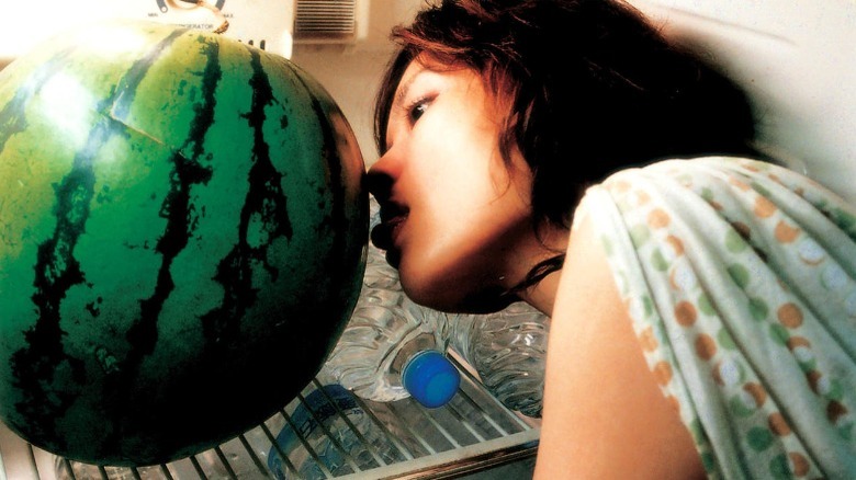 woman licking watermelon