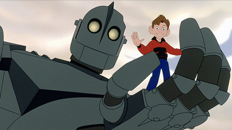 Hogarth standing in the Iron Giant's hand