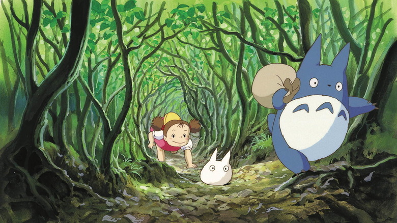 Totoro leads Mei through the woods